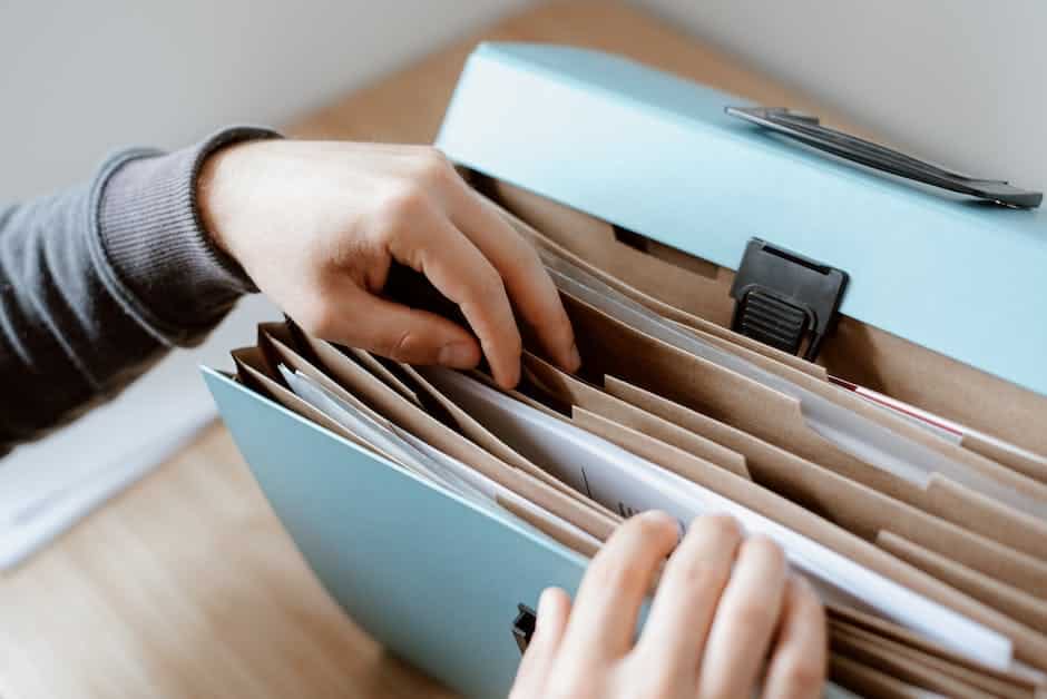 Image depicting a person searching through old documents related to slave genealogy research