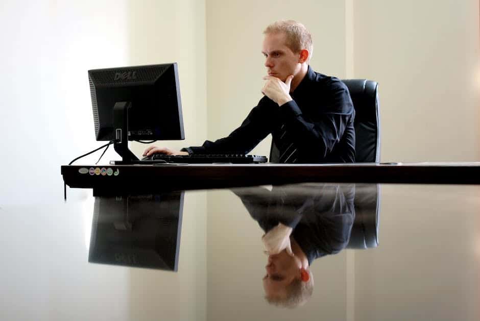 A person working on a desktop computer, used in my article devices for genealogy research.
